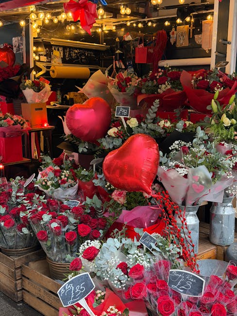 A vibrant display of fresh floral arrangements and bouquets at a flower shop on Dollis Hill Road NW2, featuring predominantly red and white flowers, including roses, carnations, and baby's breath, arr